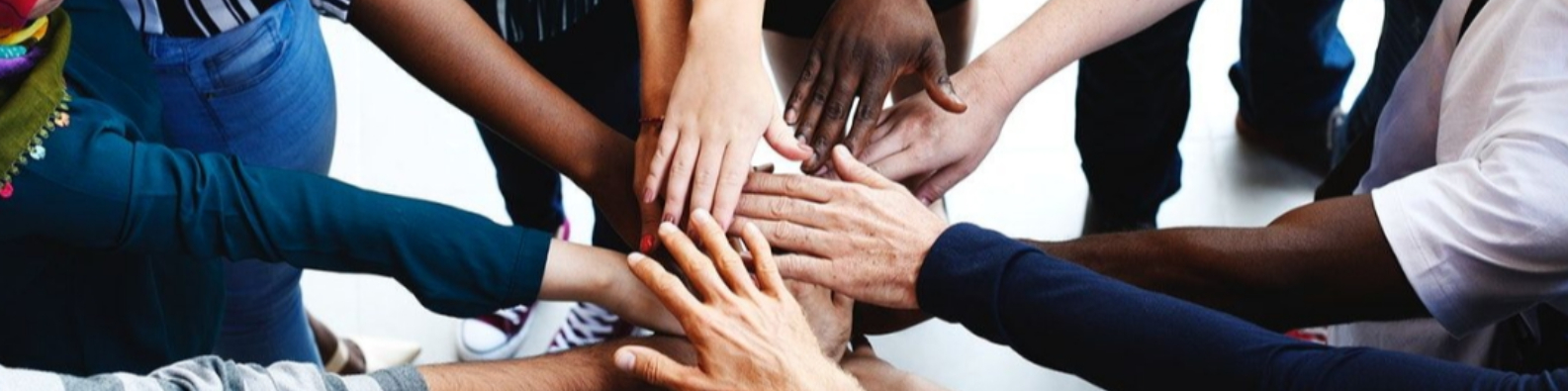 photo of multi-racial hands together in the center
